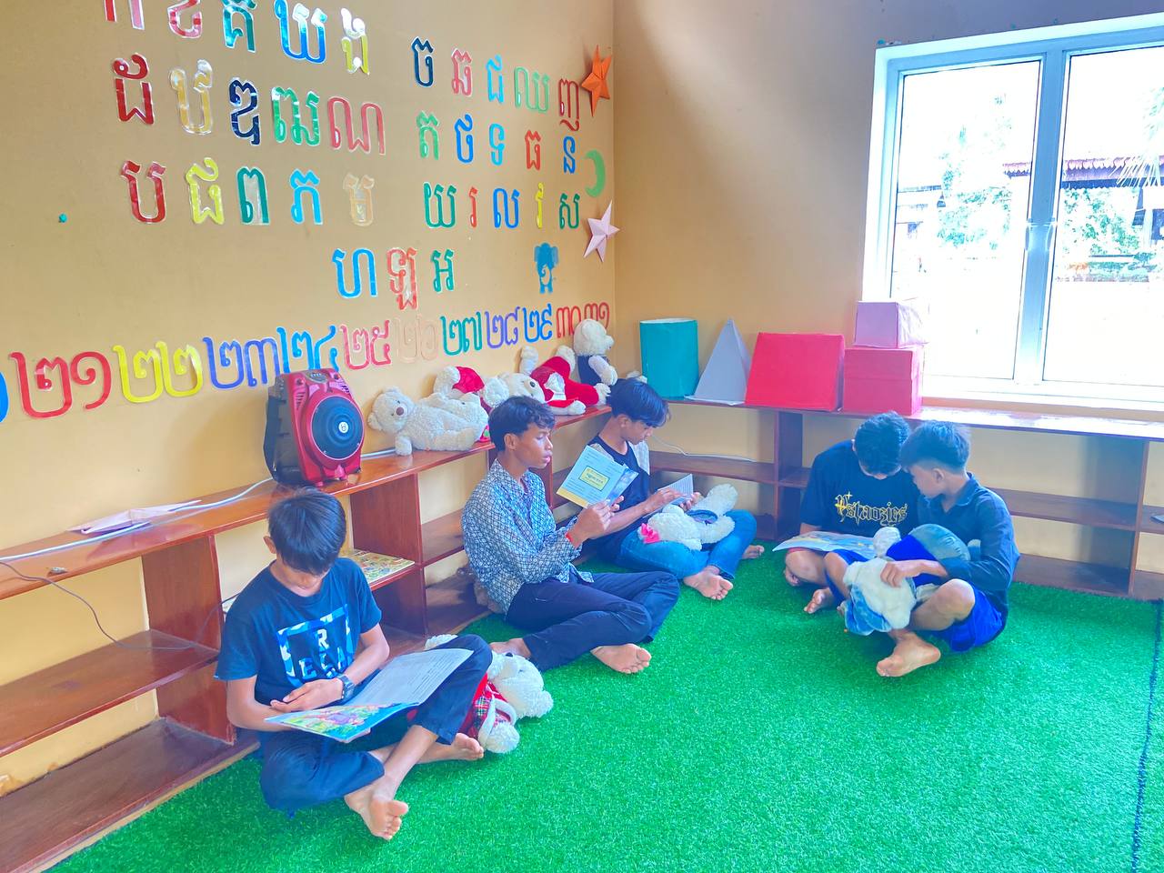 Young people in the community reading books at the library
