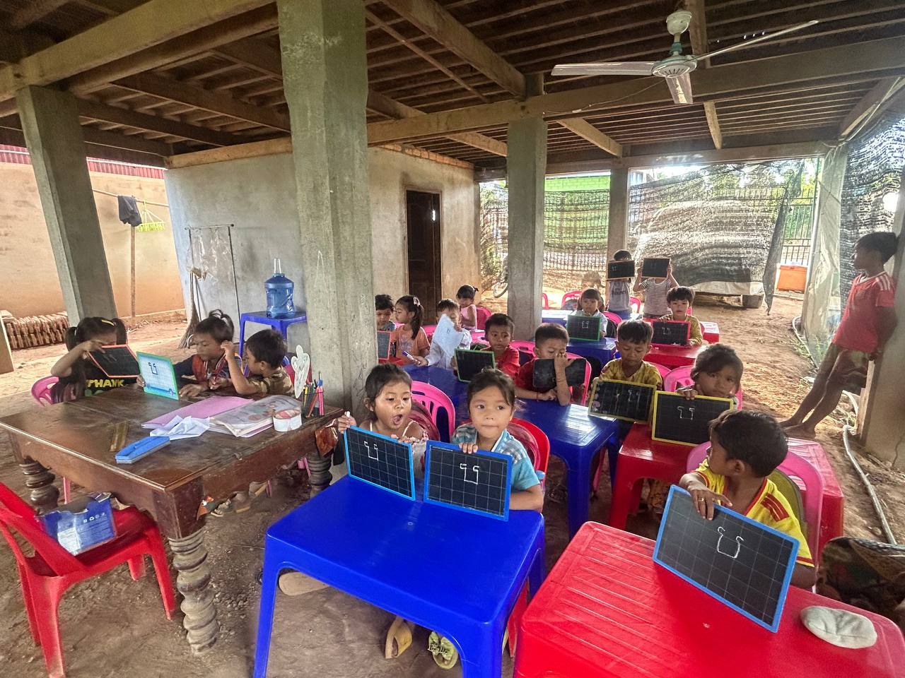 Children learning under a house